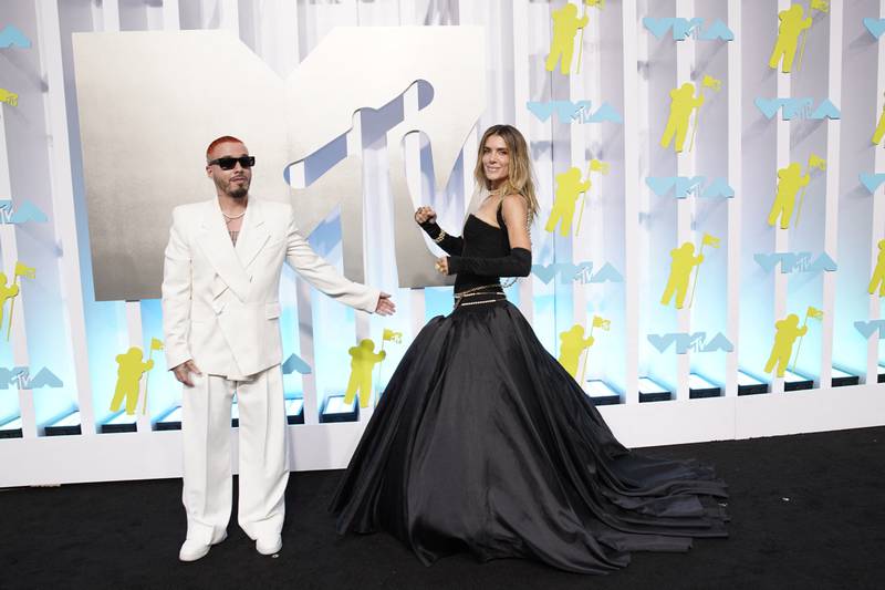 Valentina Ferrer, wearing a black gown, and J Balvin, in an oversized white suit. Reuters 