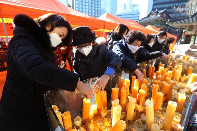 Parents place candles during a special service to wish for their children's success in the college entrance exams at the Jogyesa Buddhist temple in Seoul, South Korea. AP Photo