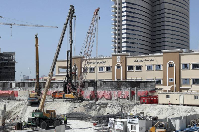 ABU DHABI , UNITED ARAB EMIRATES , FEB 18  – 2018 :- Construction going on next to the boundary wall of Repton School on Reem Island in Abu Dhabi. ( Pawan Singh / The National ) For News
