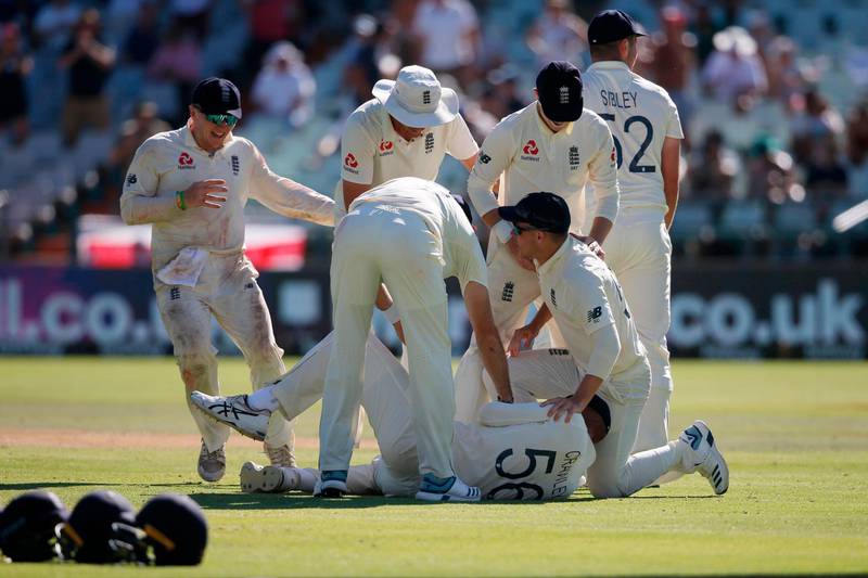 England's Zak Crawleyis mobbed by teammates after catching out Anrich Nortje. AFP