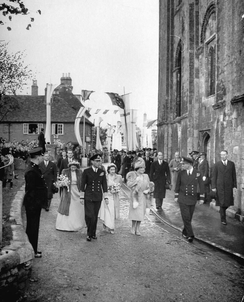 England's royal family (ctr. l-r) Princess Elizabeth, King George VI, Princess Margaret Rose, Queen Elizabeth and Prince Philip of Greece (Elizabeth's future husband) walking through streets on their way to wedding of Patricia Mountbatten to Baron Brabour  (Photo by George Rodger/The LIFE Picture Collection via Getty Images)