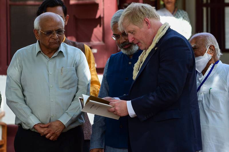The British prime minister browses a book during his visit to the Sabarmati Ashram in Ahmedabad. AFP
