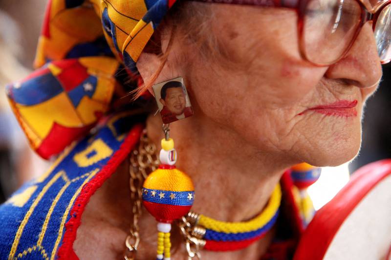A woman wears an earring bearing the image of ex-Venezuelan president Hugo Chavez at a rally marking the 10th anniversary of his death, in Caracas. Reuters