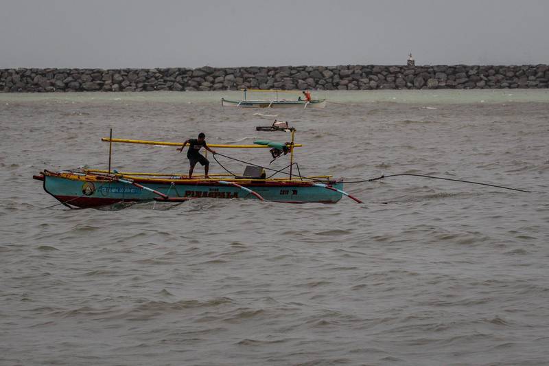 A fisherman secures his boat as typhoon Goni intensifies in Manila Bay, Manila, Philippines.   EPA