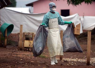 A health worker in 2005 outside a hospital in Uige, Angola, where victims of the Marburg virus were treated. 