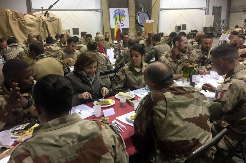 French Defence Minister Florence Parly (3rdL) has a dinner with soldiers of the Operation Barkhane, a French counter-terrorism operation in Africa's Sahel region, as they celebrate New Year's eve, on December 31, 2017 in Tessalit. / AFP PHOTO / Daphné BENOIT