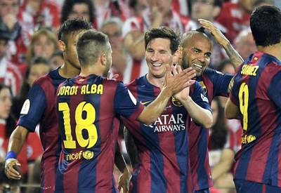 Barcelona's Argentinian forward Lionel Messi (C) celebrates with teammates after scoring during the Spanish Copa del Rey (King's Cup) final football match Athletic Club Bilbao vs FC Barcelona at the Camp Nou stadium in Barcelona on May 30, 2015.   AFP PHOTO/ LLUIS GENE (Photo by LLUIS GENE / AFP)
