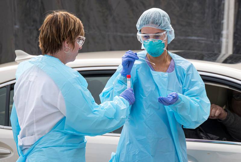 Medical personnel collect a sample from a patient at a drive-thru testing clinic at a Kaiser Permanente facility in San Francisco. Bloomberg