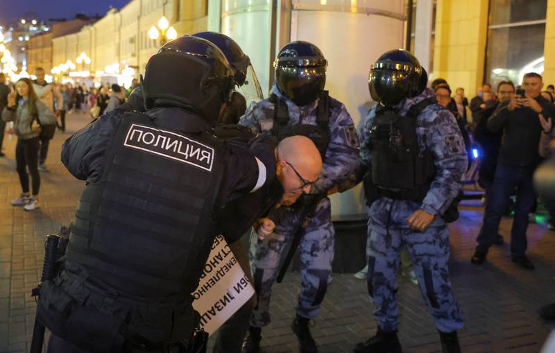 Russian police officers detain a participant during an unsanctioned rally. Reuters