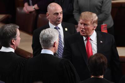 Donald Trump speaks to Supreme Court justices after delivering the State of the Union address . AFP