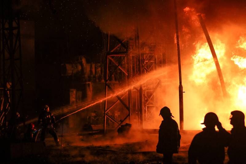Firefighters work at a site of the fifth thermal power plant damaged by a Russian missile strike. Photo: Reuters