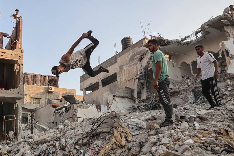 Palestinian youths practise parkour amid the rubble of buildings destroyed by Israeli air strikes in the latest round of fighting between Israel and Palestinian militants, in Rafah in the southern Gaza Strip.