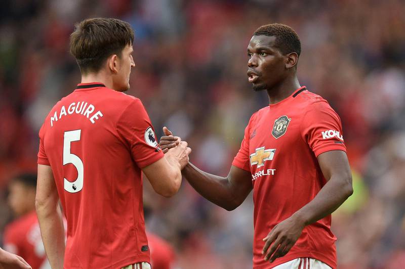Manchester United's English defender Harry Maguire (L) shakes hands with Manchester United's French midfielder Paul Pogba (R) on the pitch at the final whistle in the English Premier League football match between Manchester United and Chelsea at Old Trafford in Manchester, north west England, on August 11, 2019. Manchester United won the game 4-0. - RESTRICTED TO EDITORIAL USE. No use with unauthorized audio, video, data, fixture lists, club/league logos or 'live' services. Online in-match use limited to 120 images. An additional 40 images may be used in extra time. No video emulation. Social media in-match use limited to 120 images. An additional 40 images may be used in extra time. No use in betting publications, games or single club/league/player publications.
 / AFP / Oli SCARFF                           / RESTRICTED TO EDITORIAL USE. No use with unauthorized audio, video, data, fixture lists, club/league logos or 'live' services. Online in-match use limited to 120 images. An additional 40 images may be used in extra time. No video emulation. Social media in-match use limited to 120 images. An additional 40 images may be used in extra time. No use in betting publications, games or single club/league/player publications.
