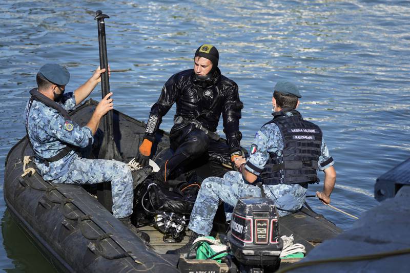 An Italian Navy diver and support team patrol the waters by the Arsenal complex of former shipyards and armories, where the G20 meeting is taking place.