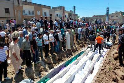 People gather at a mass burial for the victims purportedly killed during an artillery barrage from Syrian forces in Houla in this handout image dated May 26, 2012. U.N. observers in Syria have confirmed that artillery and tank shells were fired at a residential area of Houla, Syria, where at least 108 people, including many children, were killed, the U.N. chief said on Sunday in a letter to the Security Council.   REUTERS/Shaam News Network/Handout (SYRIA - Tags: POLITICS CONFLICT TPX IMAGES OF THE DAY CIVIL UNREST) FOR EDITORIAL USE ONLY. NOT FOR SALE FOR MARKETING OR ADVERTISING CAMPAIGNS *** Local Caption ***  AMM09R_SYRIA-UN-BAN_0528_11.JPG