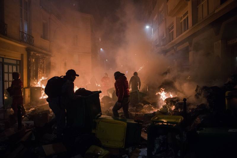 A fire burns on a Paris street on Thursday after another day of strikes and protests. Bloomberg