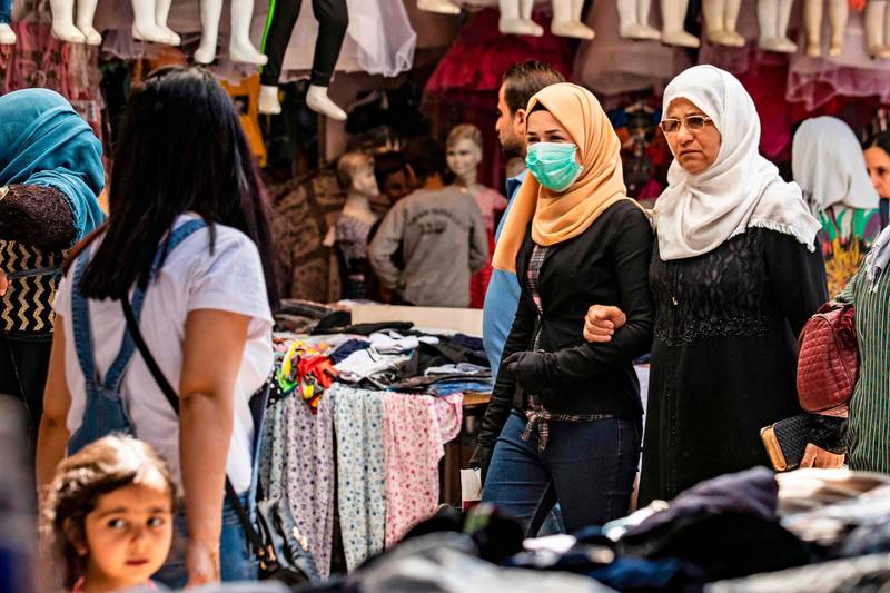 Shoppers walk through the main market of the Kurdish-majority city of Qamishli in Syria's north-east Hasakeh province. AFP