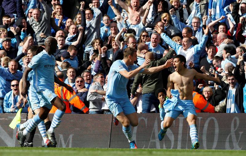 FILE PHOTO: Manchester City's Sergio Aguero (R) celebrates his winning goal with team mates Mario Balotelli (L) and Edin Dzeko during their English Premier League match against Queens Park Rangers at the Etihad Stadium in Manchester, northern England, May 13, 2012.           REUTERS/Darren Staples (BRITAIN  - Tags: SPORT SOCCER) FOR EDITORIAL USE ONLY. NOT FOR SALE FOR MARKETING OR ADVERTISING CAMPAIGNS. EDITORIAL USE ONLY. NO USE WITH UNAUTHORIZED AUDIO, VIDEO, DATA, FIXTURE LISTS, CLUB/LEAGUE LOGOS OR ?LIVE? SERVICES. ONLINE IN-MATCH USE LIMITED TO 45 IMAGES, NO VIDEO EMULATION. NO USE IN BETTING, GAMES OR SINGLE CLUB/LEAGUE/PLAYER PUBLICATIONS./File Photo