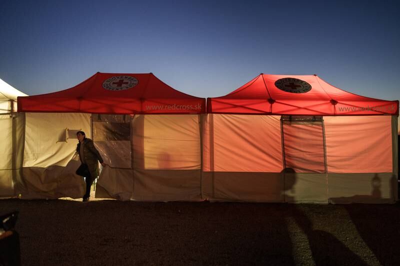 A Ukrainian woman emerges from a Red Cross tent at a border crossing in Slovakia. Getty