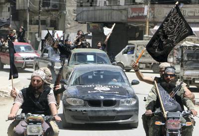 Fighters from Al-Qaeda's Syrian affiliate Al-Nusra Front drive in the northern Syrian city of Aleppo flying Islamist flags as they head to a frontline, on May 26, 2015. Once Syria's economic powerhouse, Aleppo has been divided between government control in the city's west and rebel control in the east since shortly after fighting there began in mid-2012. AFP PHOTO / AMC / FADI AL-HALABI (Photo by Fadi al-Halabi / AMC / AFP)