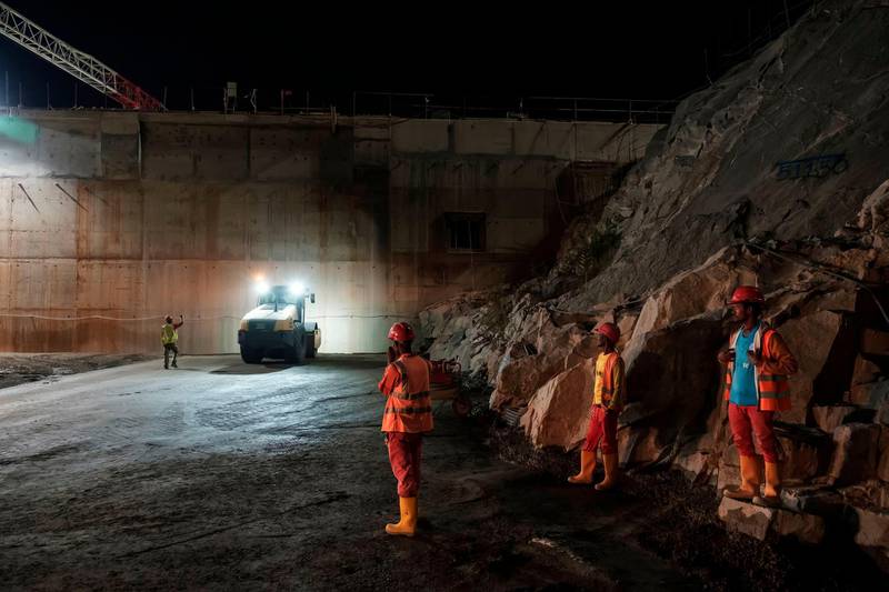 Construction workers work at night at the Grand Ethiopian Renaissance Dam (GERD), near Guba in Ethiopia.  AFP
