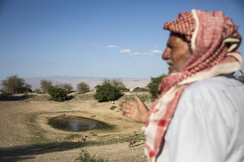 Local Palestinian shepherd who goes by the nick name of Abu Ibrahim stands nearby a dried-up small reservoir in the Palestinian village of Auja in the Jordan Valley .Abu Ibrahim has lived in Auja village his whole life and raised five children on these lands. But he said heÕs not fond of his newer neighbors: the rich Palestinians from Ramallah or other cities who donÕt care about farming and bought up the land as weekend get-a-ways from the original owners who had to sell as water levels dwindled. 

(Photo by Heidi Levine for The National). 
