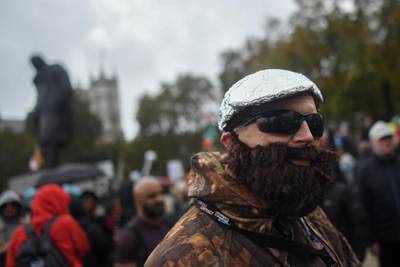A protester wearing a tin foil hat is seen in Parliament Square during a Unite for Freedom march in London. Getty Images