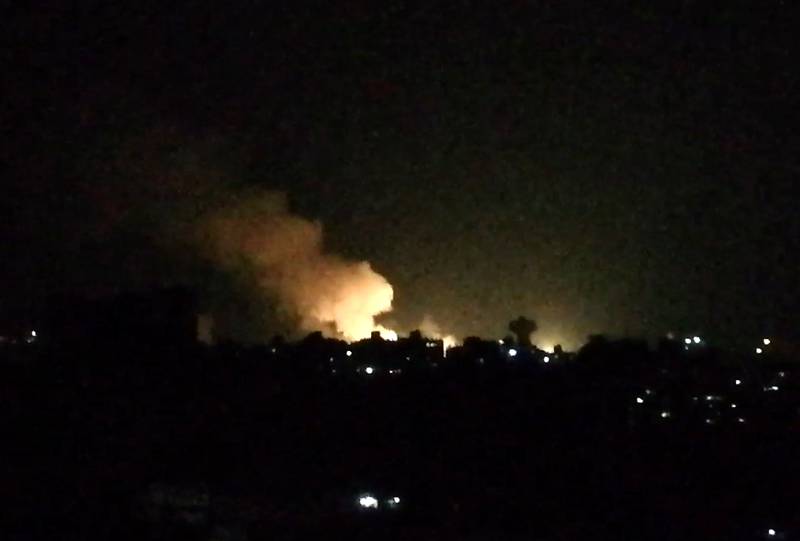 An image grab taken from an AFP video shows what appears to be smoke billowing over buildings near the Syrian capital Damascus, following a reported Israeli air strike overnight on July 1, 2019.  Israeli air strikes near Damascus and in Homs province left more than a dozen people dead,  a Britain-based war monitor said Monday. / AFP / Youssef KARWASHAN

