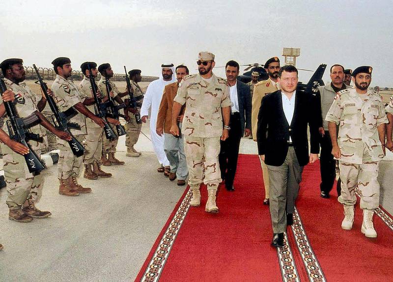 King Abdullah of Jordan (C) reviews an Emirati honor guard, escorted by UAE chief of Staff Sheikh Mohammed bin Zayed,  during his visit to a military school in Abu Dhabi 08 January 2002. The Jordanian monarch is visiting the UAE and Bahrain for talks on bilateral ties and international developments. After years of tension which followed the 1990-91 Gulf War crisis, relations between Amman and the Gulf's oil monarchies have thawed over the past four years. AFP PHOTO/WAM (Photo by WAM / AFP)