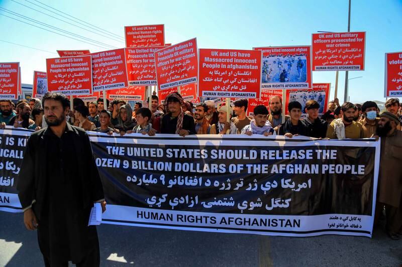 Afghans in Kabul hold placards during a protest against the US move to transfer $3.5 billion in Afghan central bank assets to a new Swiss-based trust fund. EPA