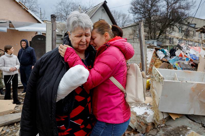 Resident Svetlana Boiko, 66, who was wounded in recent shelling, is comforted near her destroyed house in Donetsk. Reuters