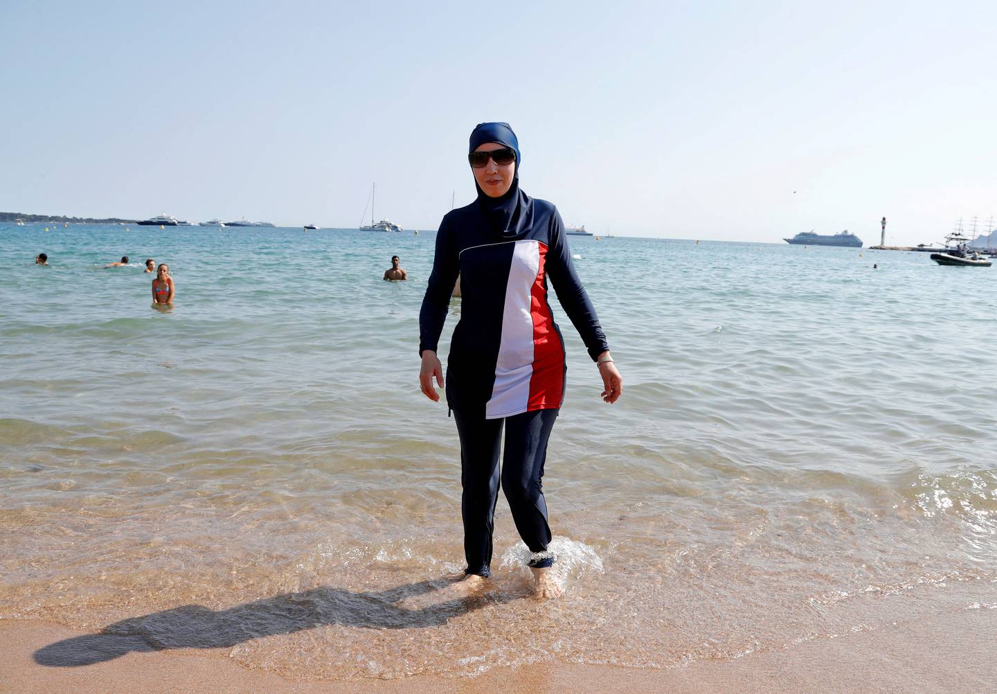 A woman wears a full-body swimsuit on a beach in Cannes after a call to support the wearing of burkinis. Reuters