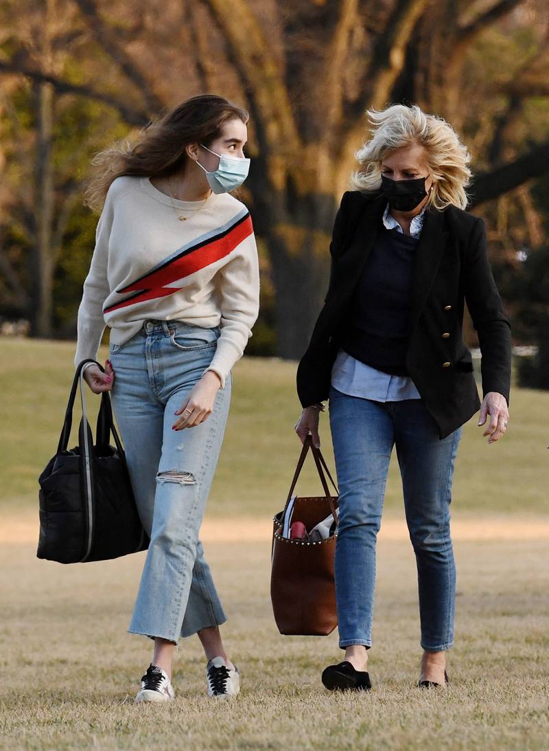 Jill Biden is dressed down in jeans and a jumper as she walks with her granddaughter Natalie Biden, across the White House South Lawn on March 14, 2021. AFP