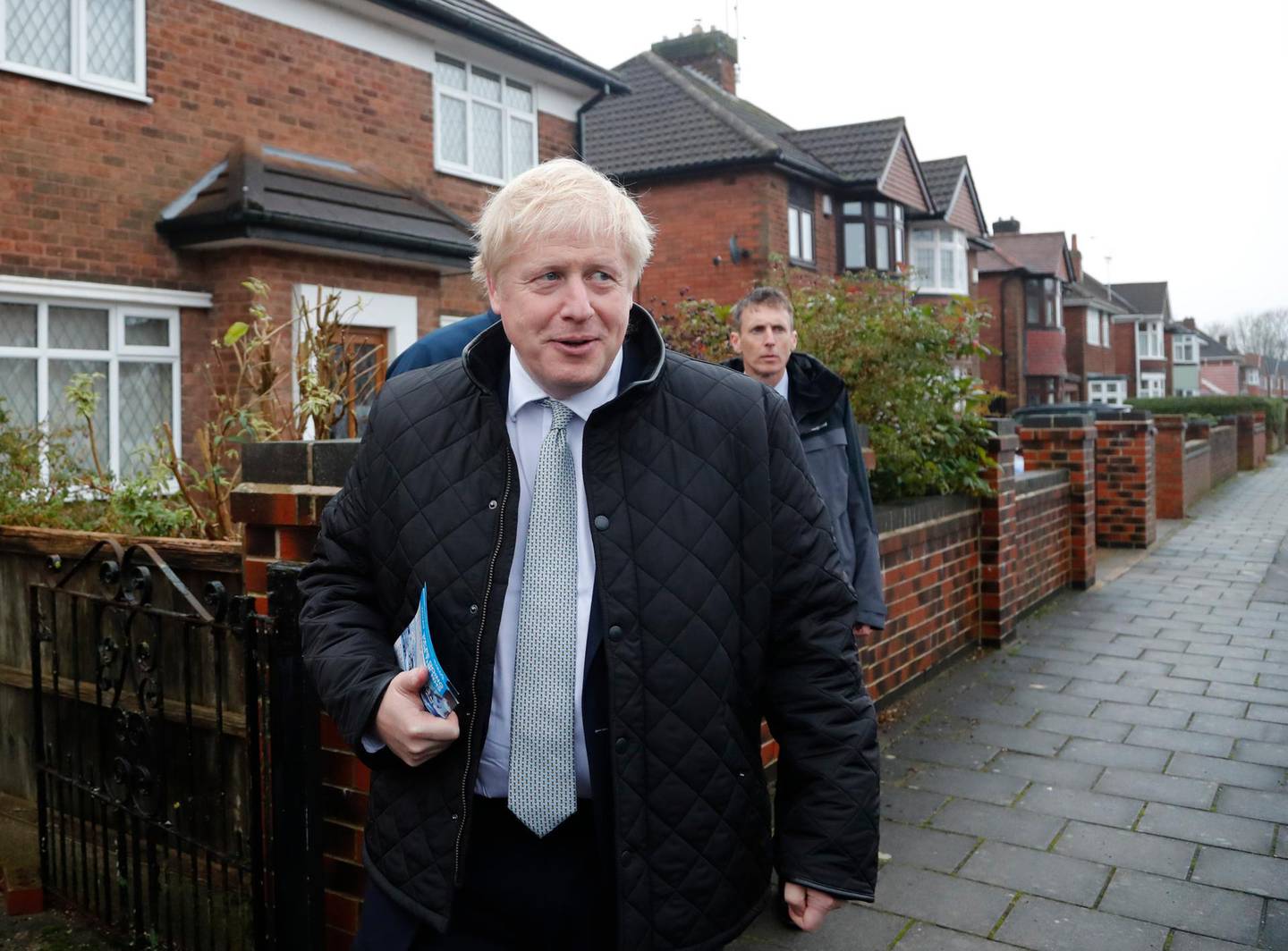 Britain's Prime Minister Boris Johnson, right with the Conservative party candidate for the Mansfield constituency Ben Bradley, second right canvasing during a General Election campaign trail stop in Mansfield, England, Saturday, Nov. 16, 2019. Britain goes to the polls on Dec.12. (AP Photo/Frank Augstein, Pool)