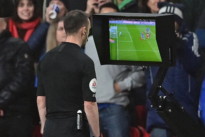 English referee Stuart Attwell checks the pitch-side monitor after being advised of a foul by VAR, before disallowing a goal from Liverpool's Joel Matip. AFP