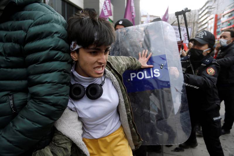 A demonstrator scuffles with riot police at a rally in the run-up to International Women's Day, in Ankara, Turkey. Reuters