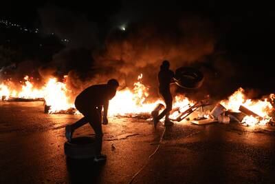 Palestinians burn tyres near the Huwwara checkpoint, south of the West Bank city of Nablus, during a protest against Israel's air strikes in Gaza. EPA
