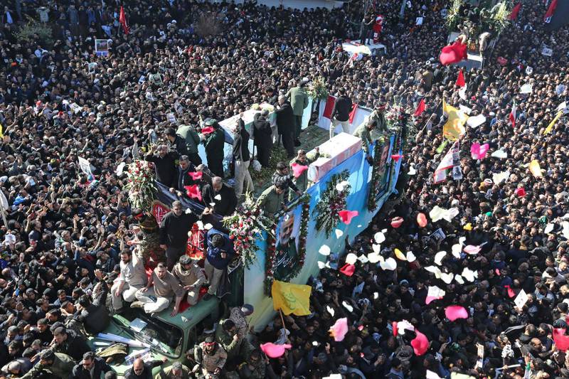 Iranian mourners gather around a vehicle carrying the coffin Qassem Suleimani during the final stage of funeral processions, in his hometown Kerman. AFP