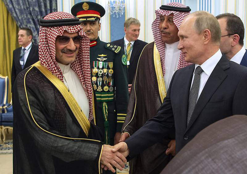 Mr Putin shakes hands with Saudi Prince AlWaleed bin Talal in Riyadh. AFP