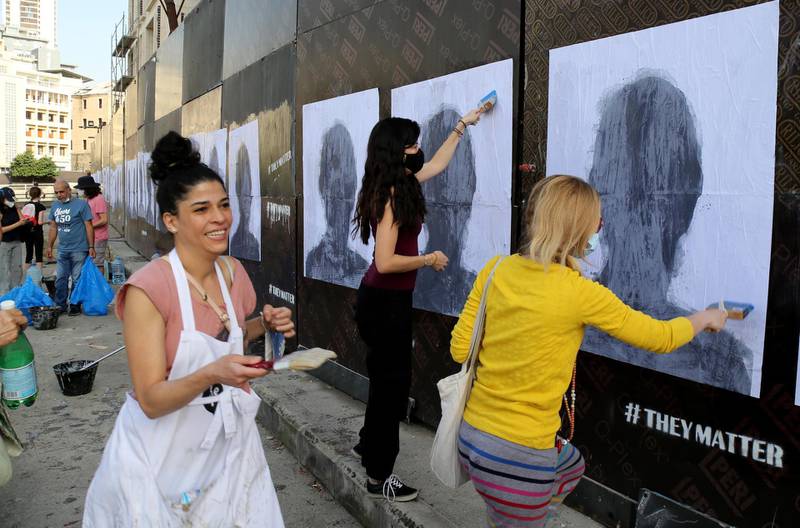Activists hang portraits of August 4 Beirut blast victims on a wall in the Lebanese capital. Artist Brady Black, in partnership with the Art of Change organisation, commemorated the deadly explosion that killed more than 200 people. EPA