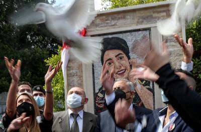 On the eve of International Women's Day, in Lebanon's capital city, the governor of Beirut, Judge Marwan Abboud, and relatives of the late Lebanese paramedic Sahar Fare, release doves in front of a commemorative portrait to honour the first female victim in the military corps. EPA