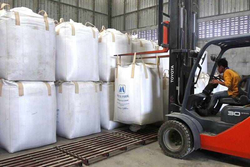 A worker uses a forklift to lift sacks of rice at a mill. Thailand is in battle to offload grain from around 18 million tonnes in national stocks after an audit noted that 70 per cent is deteriorating and another fifth is inedible. Chaiwat Subprasom / Reuters