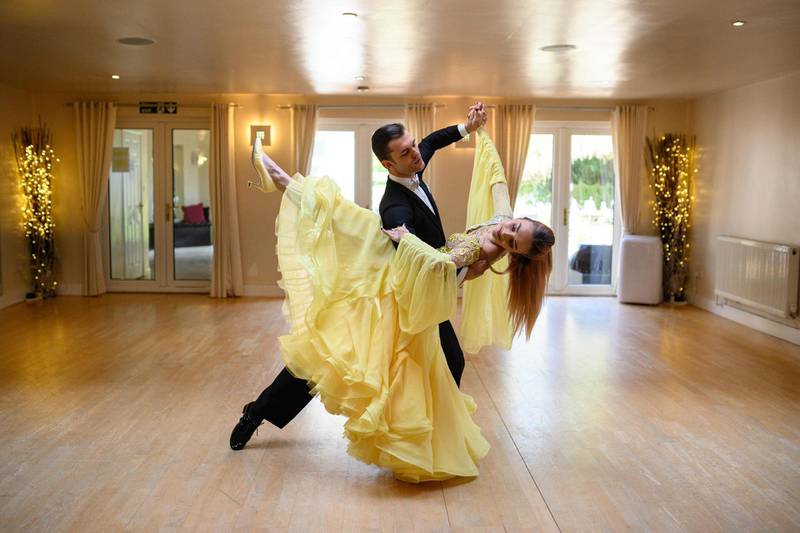 Ballroom dancers Roman Sukhomlyn and India Phillips, the North of England Champions at the British National Dance Championships, practice at their home during the lockdown in Wolverhampton, central England. AFP