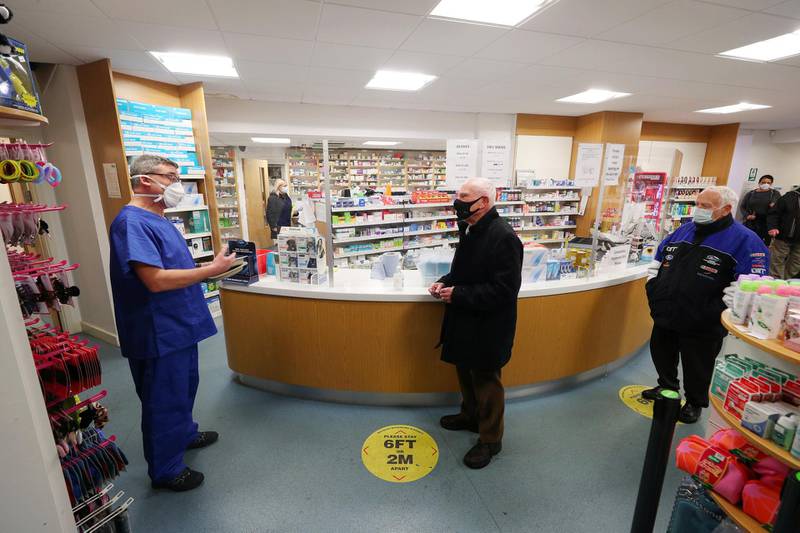 Pharmacist Andrew Hodgson speaks to Robert Salt, 82, before he receives a vaccine at Andrews Pharmacy in Macclesfield. Reuters