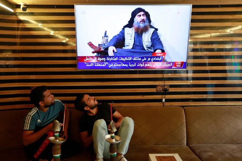 Iraqi youth watch the news of Islamic State leader Abu Bakr al-Baghdadi death, in Najaf, Iraq October 27, 2019. REUTERS/Alaa al-Marjani