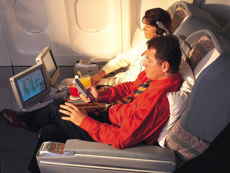 Passengers enjoy the new video system. Courtesy Emirates