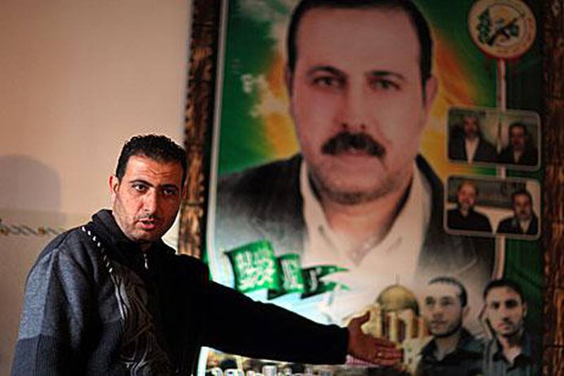 Fayek Al Mabhouh in front of his brother's poster at the family house in northern Gaza Strip's Jabaliya refugee camp.