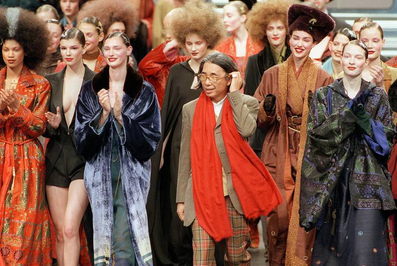 Japanese fashion designer Kenzo, centre, salutes the audience at the end of his ready-to-wear fall / Winter 1998/99 collection presentation in Paris on March 13, 1998. AFP