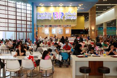 Customers eat at a Baskin Robbins outlet at the Dubai Mall. Bloomberg