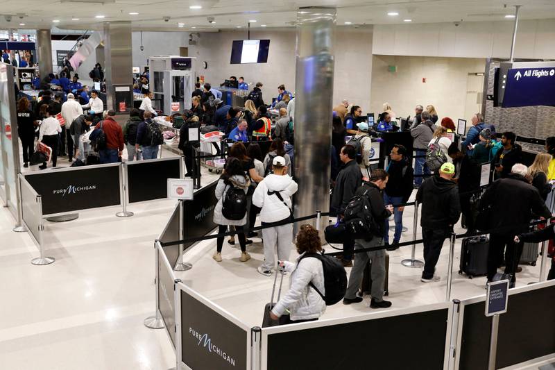 Passengers queue to go through security amid disruption at Detroit Metro Airport in Romulus, Michigan. AFP